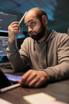 Thoughtful developer brainstorming ideas to find source code Foto stock