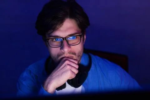 Thoughtful Developer Looking At Computer Screen Working From Home, Low-Light Stock Photos