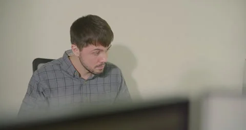 Thoughtful Developer Working Alone in Bright Minimalist Office. 스톡 동영상 306740012