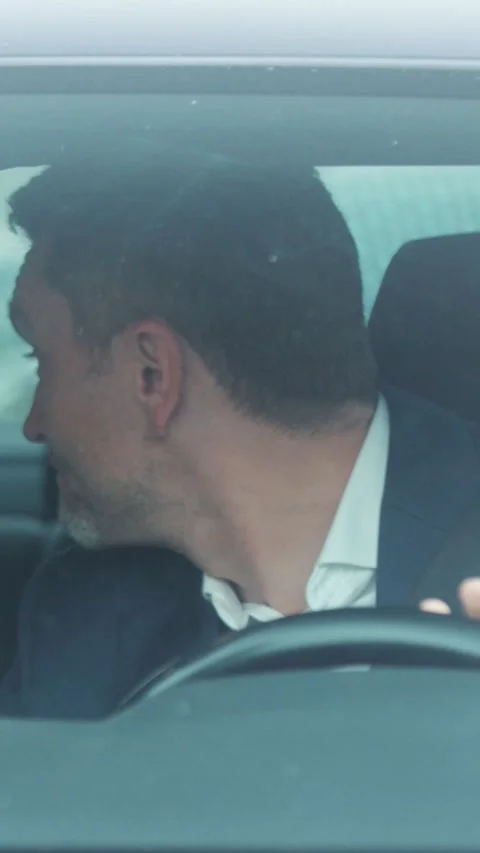 A thoughtful driver in an urban setting, reflecting emotions and experiences Stock Footage 316535431