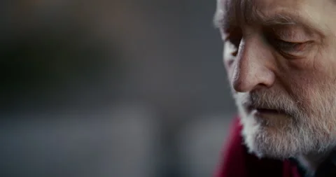 Thoughtful elderly bearded man in close-up side profile with dramatic lighting Stock Footage 336280527
