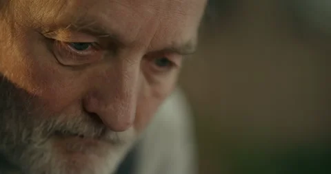 Thoughtful elderly bearded man in soft indoor light close-up Stock Footage 336285352