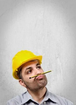 Thoughtful engineer with helmet on head 写真素材
