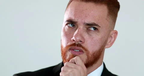 Thoughtful executive man looking for solution to problem, redhair pensive per Stock Footage 132268148
