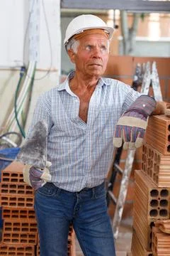 Thoughtful foreman near stack of bricks Stock Photos