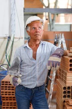 Thoughtful foreman near stack of bricks Stock Photos
