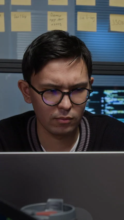 Thoughtful Gen Z Programmer Looking at Laptop Screen Fixing Bugs in Software Stock Footage 329616973