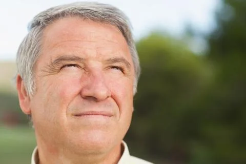 Thoughtful grey haired man looking into distance Stock Photos