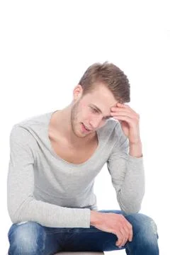 Thoughtful Handsome Guy Sitting on a Small Chair Stock Photos