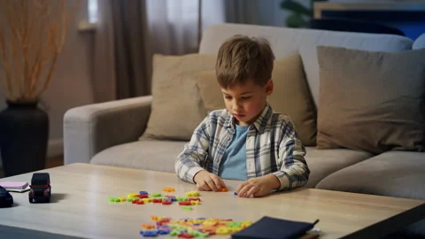 Thoughtful kid solving math equations using number toys, early STEM education Stock Footage 325129796