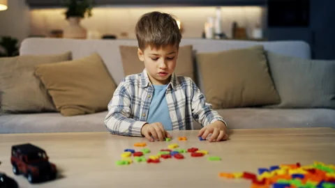 Thoughtful little boy solving math equation using toy number set, education Stock Footage 321358886