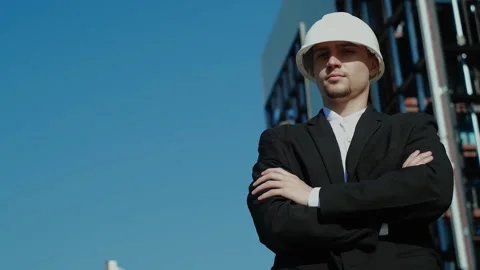 Thoughtful male builder is thinking about something with his arms crossed at the Stock Footage 249263159