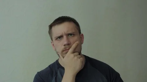 Thoughtful man agrees. Looking at camera. Video stock 77324809