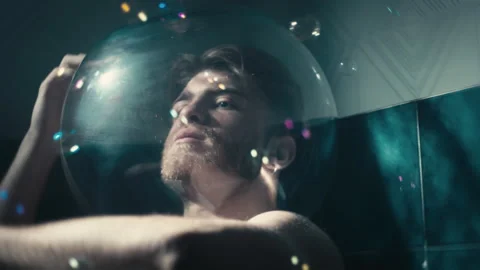 Thoughtful man alone wrapped in soap bubbles Stock Footage 196399995