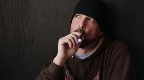 Thoughtful Man  with Beanie Cap and Beard Vapes Smokes an E-Cigarette Stock Footage 46063733