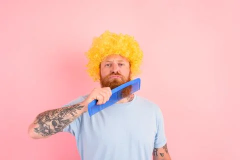 Thoughtful man with beard, yellow peruke and big comb Stock Photos