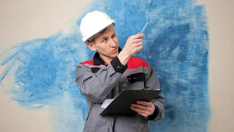 Thoughtful man builder in workwear draws renovation scheme Stock Footage 153011733