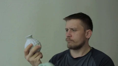 Thoughtful man choosing between vases. Video stock 77413603