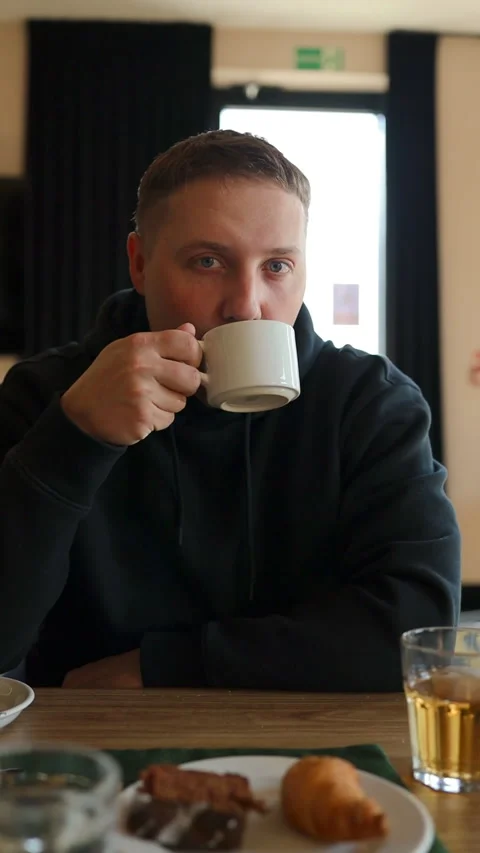 Thoughtful man drinking coffee from cup at breakfast in cafe Stock Footage 341951303