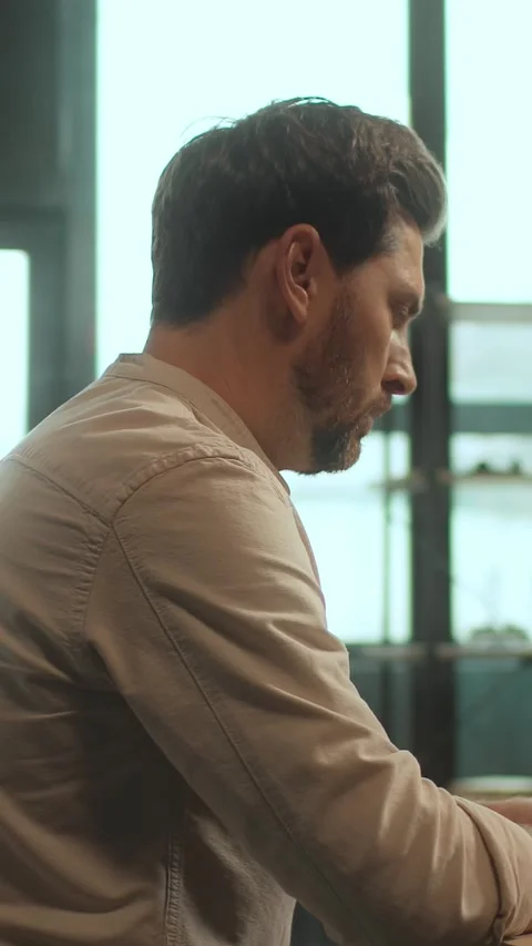 A thoughtful man engages in work, reading, and introspection Stock Footage 317844092