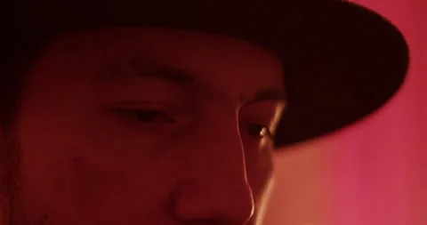 Thoughtful man in hat during lightning strikes Stock Footage 260557740