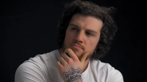 Thoughtful man isolated on black background Stock Footage 126724763