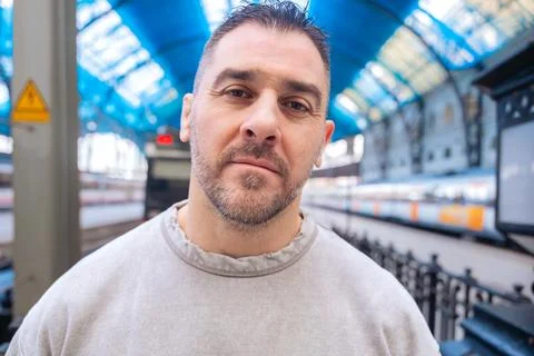 Thoughtful Man Looking Up at Train Station looking at camera Stock Photos