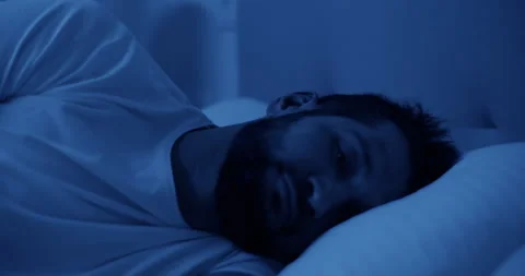 Thoughtful man lying on bed and sleepless at night Stock Footage 271159701