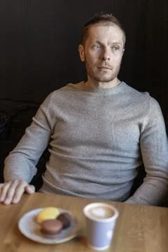 Thoughtful Man Sitting at Cafe Table Looking Away Front View Stock Photos