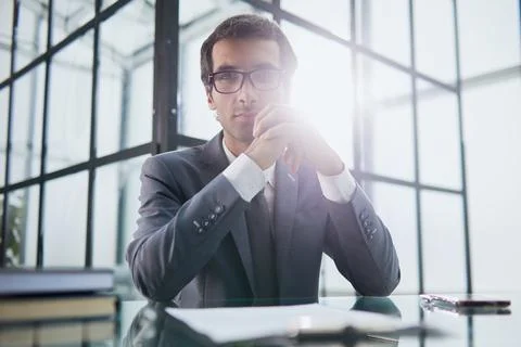 Thoughtful man sitting at the table thinking about solving a problem, Stock Photos