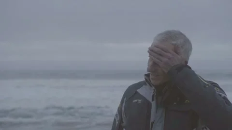 Thoughtful man standing on beach Stock Footage 63465294