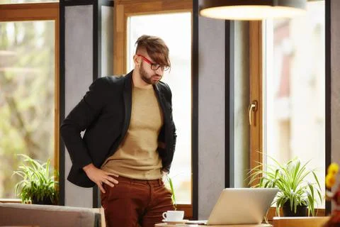 Thoughtful man standing at notebook Stock Photos