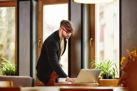 Thoughtful man standing at notebook Stock Photos