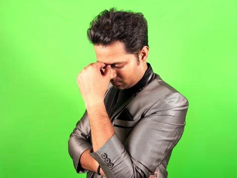 Thoughtful man in a thinking posing against a green screen background with .. Stock Photos