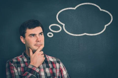 Thoughtful man with thought bubble on blackboard Stock Photos