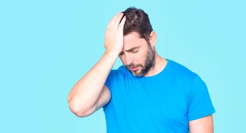 Thoughtful man touching forehead with palm. Man lost in deep thought. Man Фото