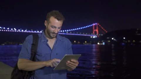 Thoughtful man using tablet at night. Stock Footage 212851276