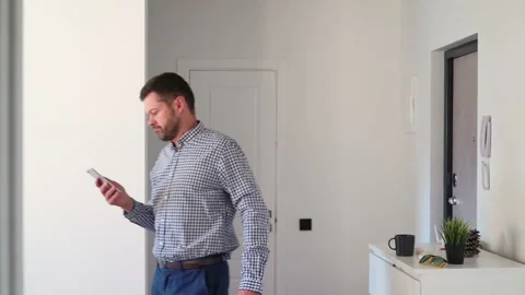 Thoughtful man walks from side to side in the room Stock Footage 157228060