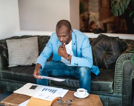 Thoughtful man watching at document Stock Photos
