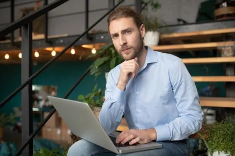 Thoughtful man working with his computer out of office Foto stock