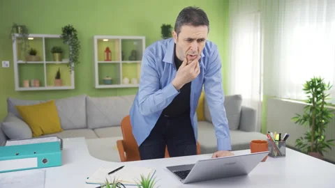 Thoughtful man working standing in his home office. Stock-Footage 237050093
