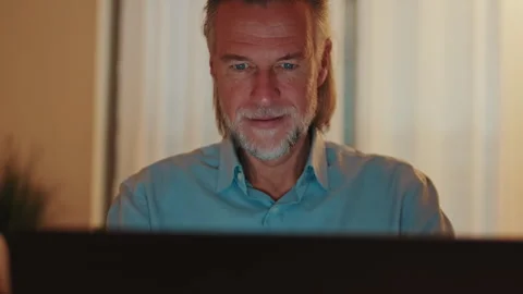 Thoughtful Mature Man Concentrating While Working on Laptop at Home Stock Footage 341767460