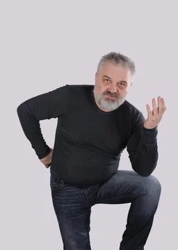 Thoughtful mature man explaining something with hand gesture 스톡 사진