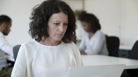 Thoughtful mature programmer working with laptop Video stock 117369707