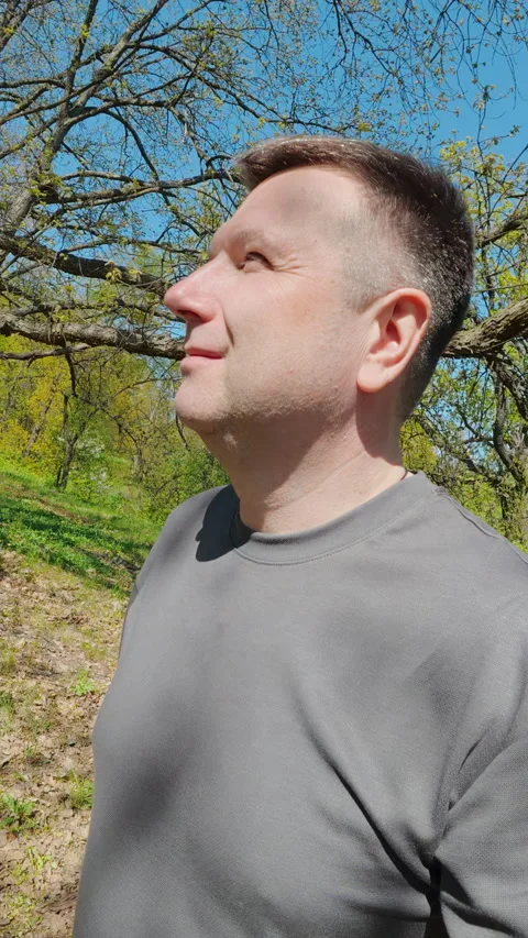 Thoughtful Middle Aged Man Standing In Sunny Spring Garden Stockbeeldmateriaal 336540446