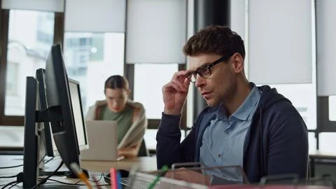 Thoughtful office manager typing computer. Focused software engineer programming Photos