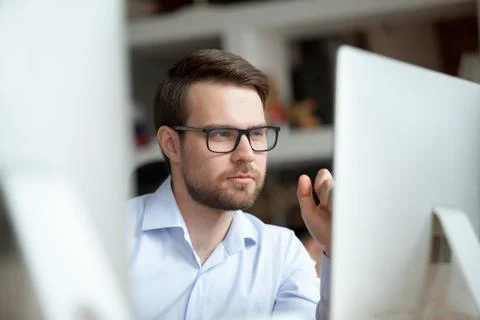 Thoughtful office worker thinking of problem solution looking at computer 스톡 사진