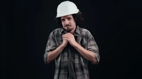 The thoughtful, optimistic engineer with the white helmet opens his hands for a Stock Footage 156282435