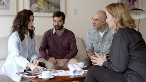 Thoughtful owners talking with interior designer Stock Footage 121005192