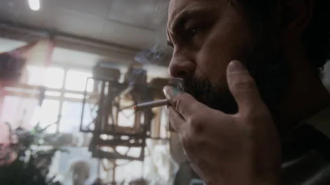 Thoughtful Painter Smoking Cigarette during Artistic Process in Studio Stock Footage 334715885
